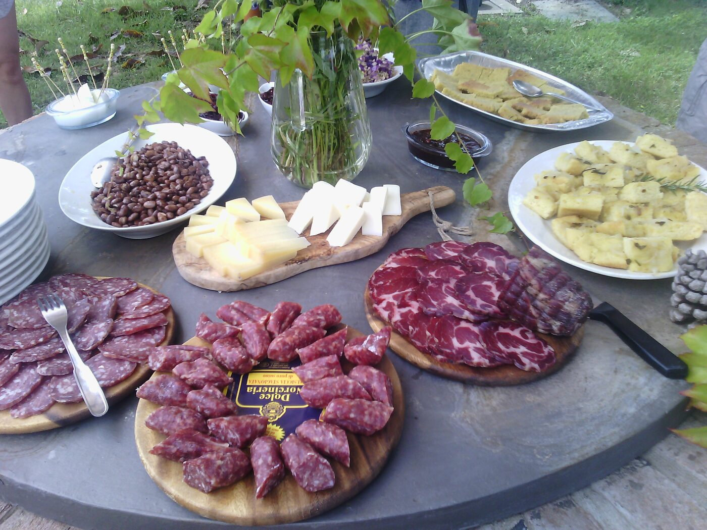 Boards of Umbrian cured meats and cheeses on an outdoor table