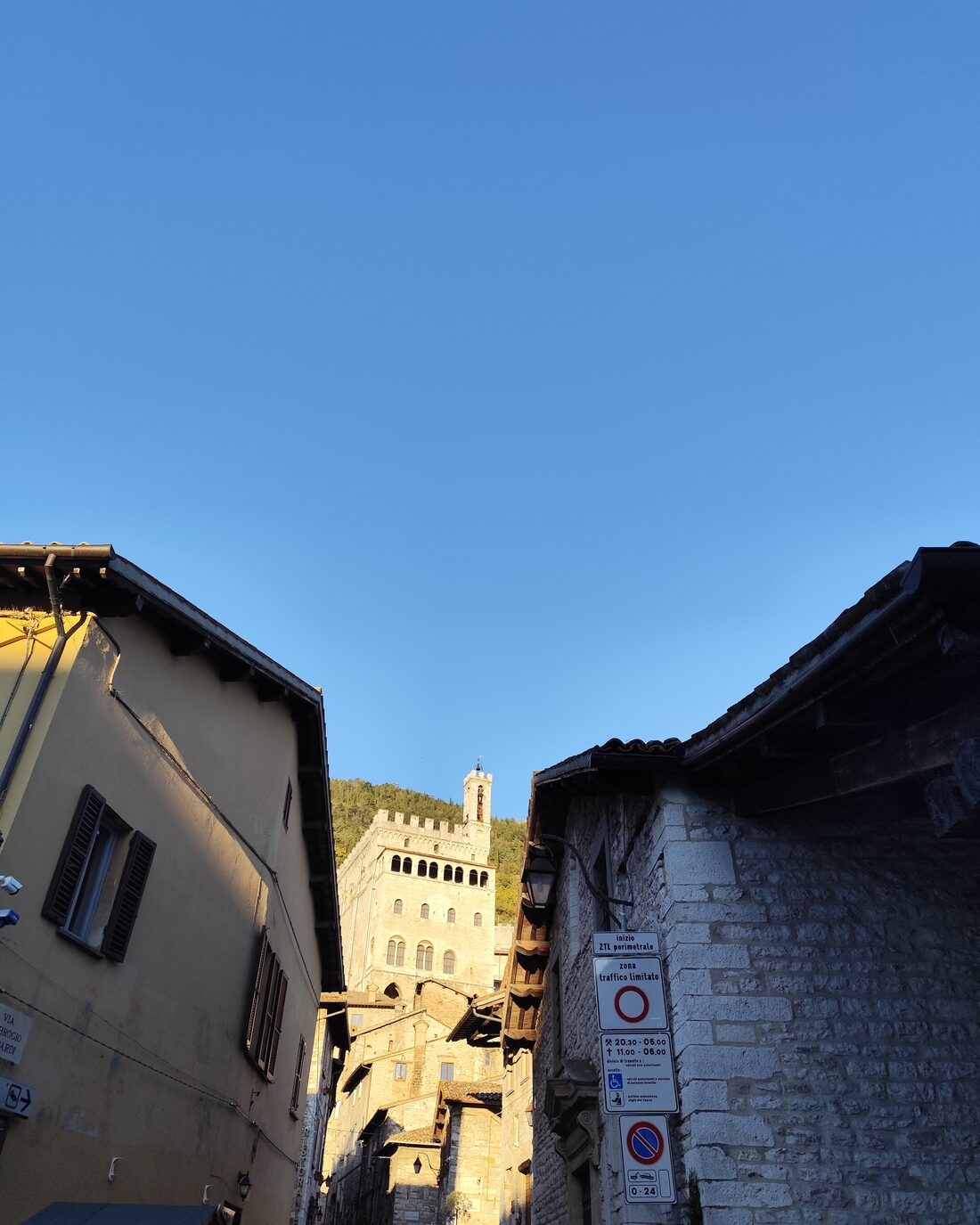 A street in Gubbio with the Palazzo dei Consoli in the background