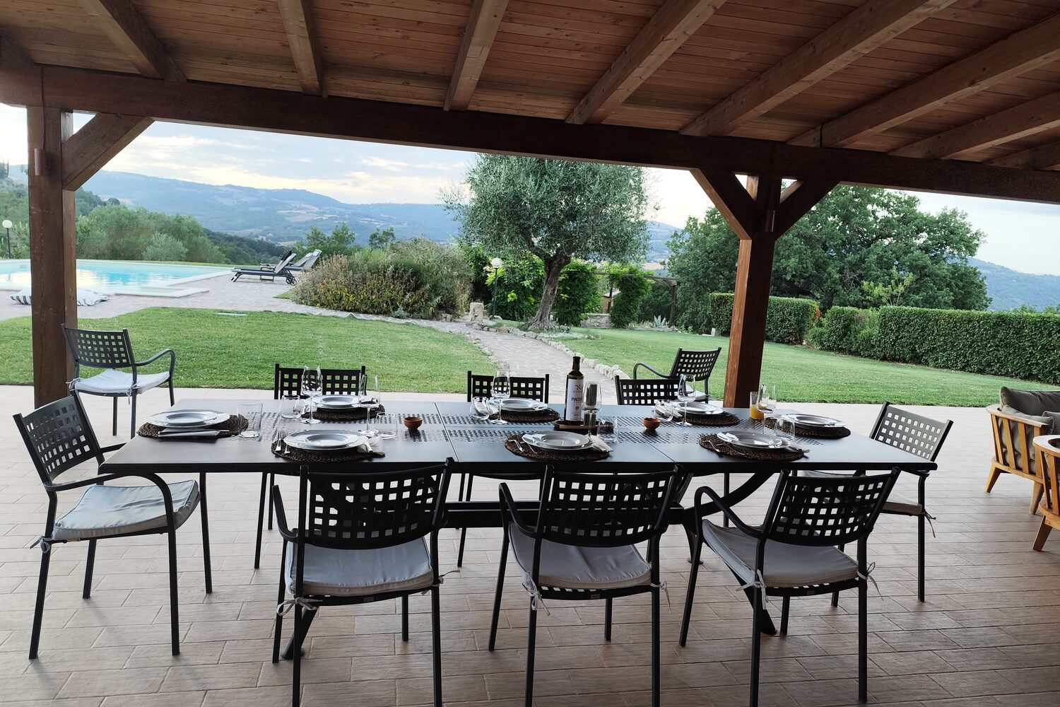 A long table laid under the loggia of an Umbrian villa